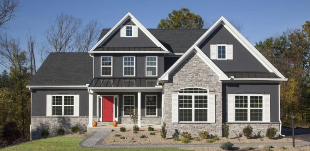 Beautiful gray home with red door and white brick with stunning landscape